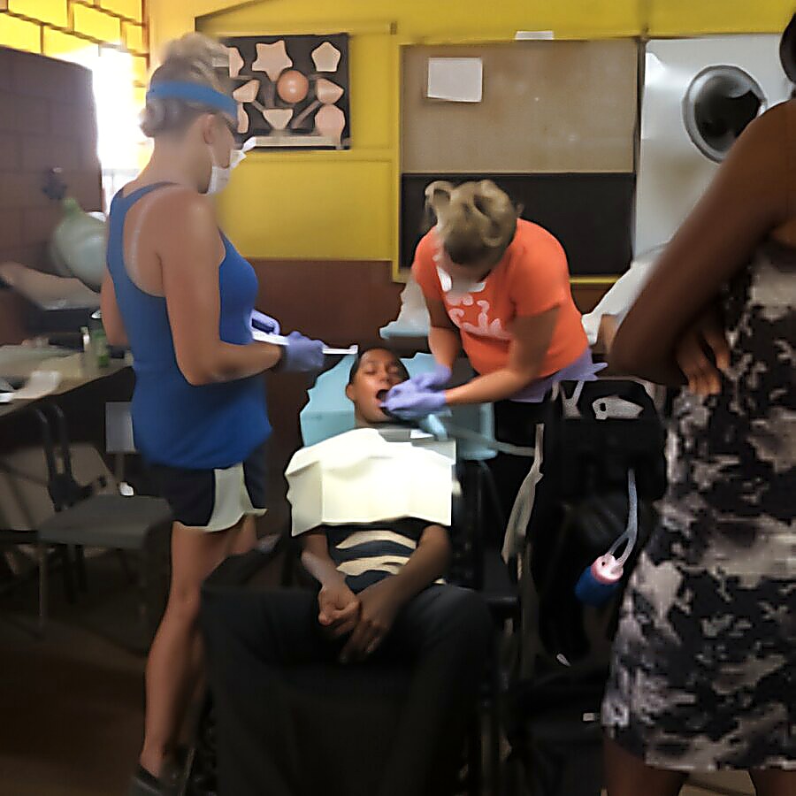 Volunteers treating a young patient during a clinic day