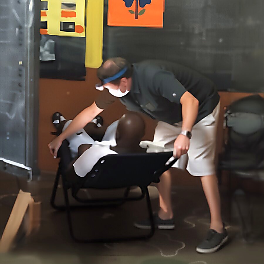 Dr. Will treating a patient in a folding chair
