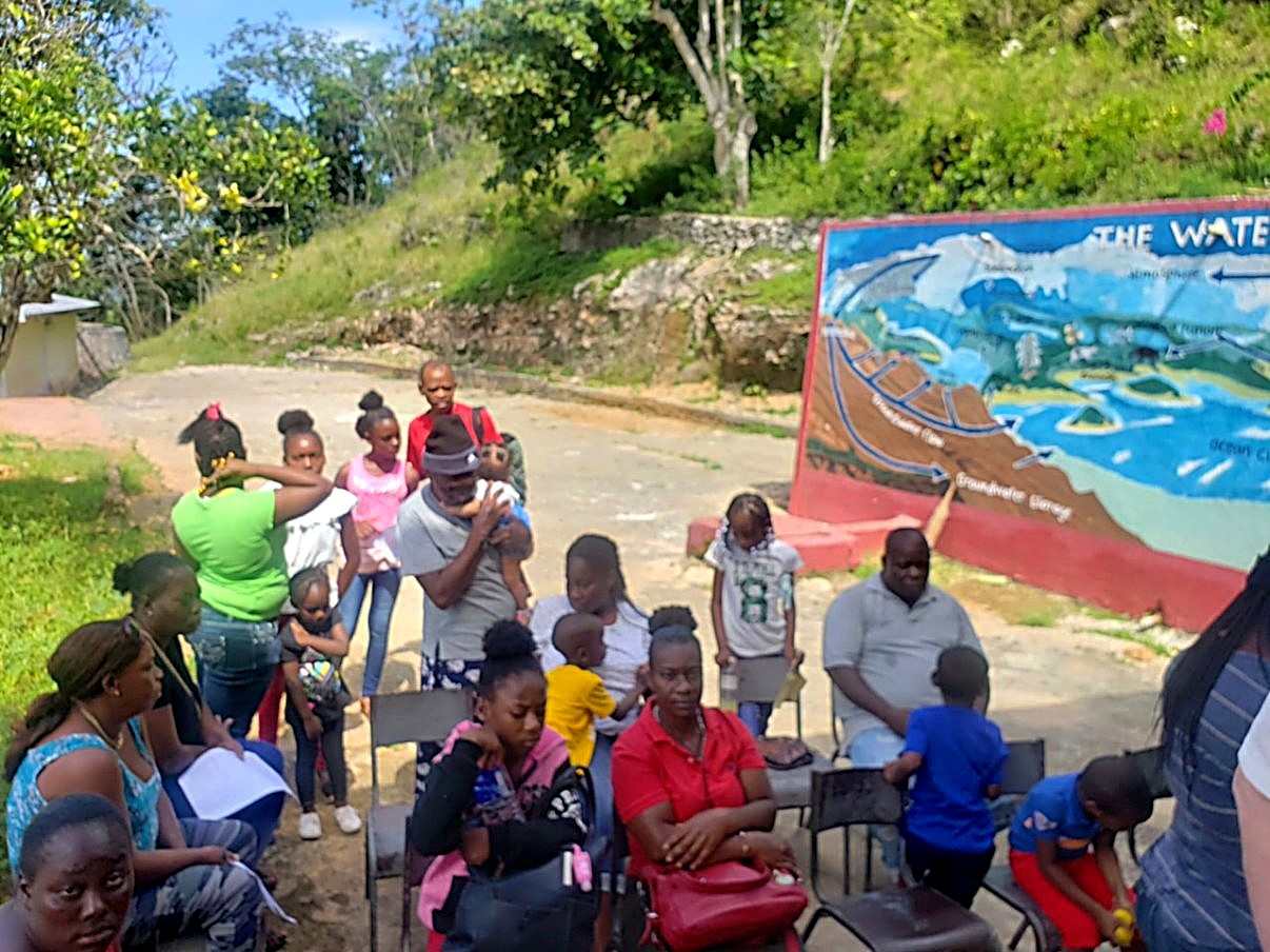 Parents and children waiting outside on the first clinic day