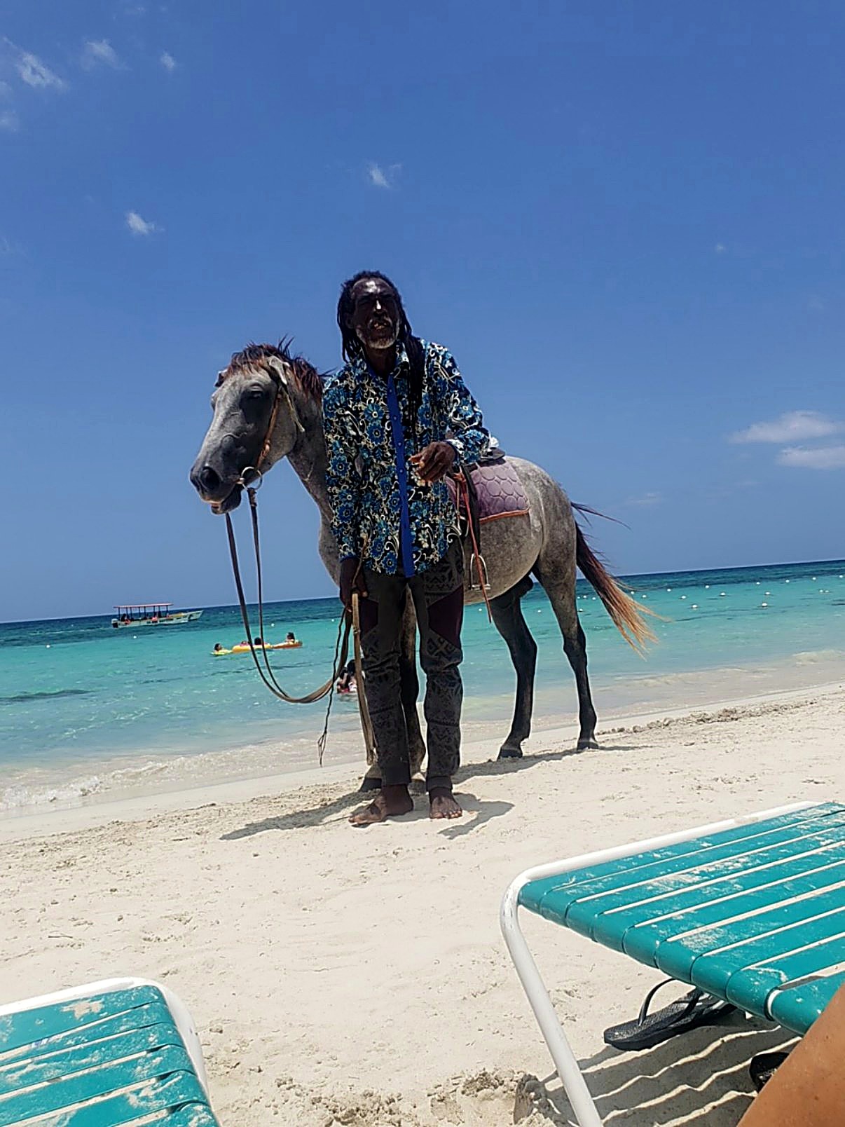 A local horseman and his horse on the beach in Jamaica