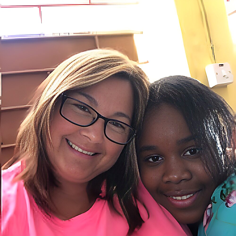 A volunteer with a young friend from the community