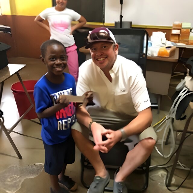 Dr. Will with a young patient after his treatment