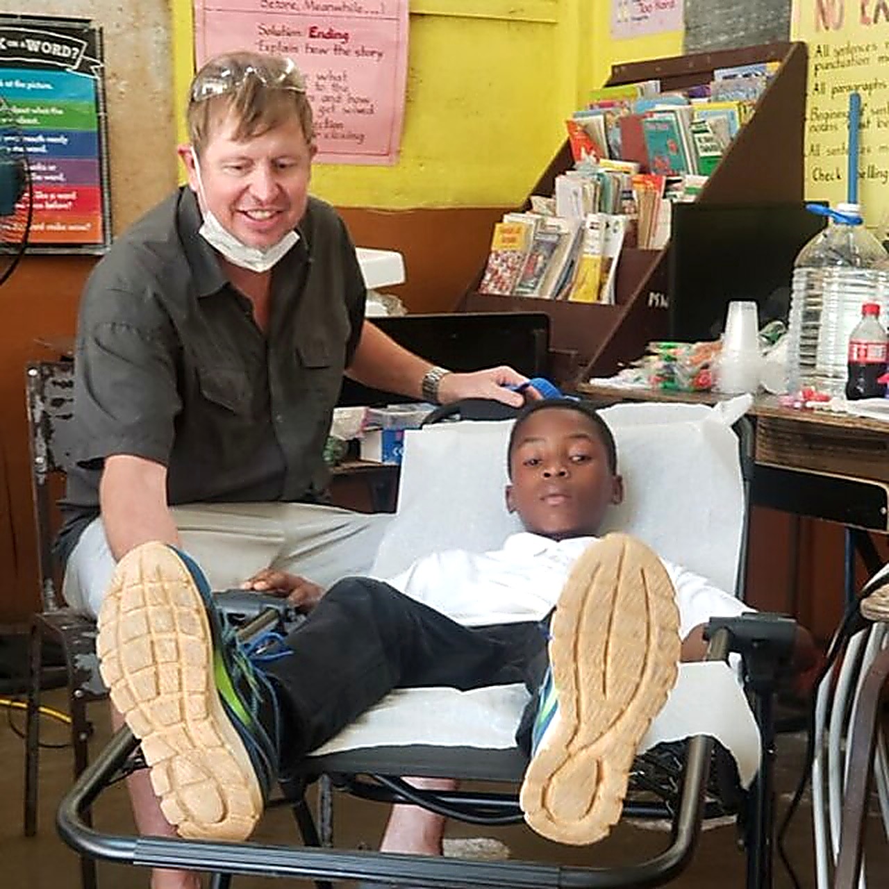 Dr. Will with a patient in the field clinic chair