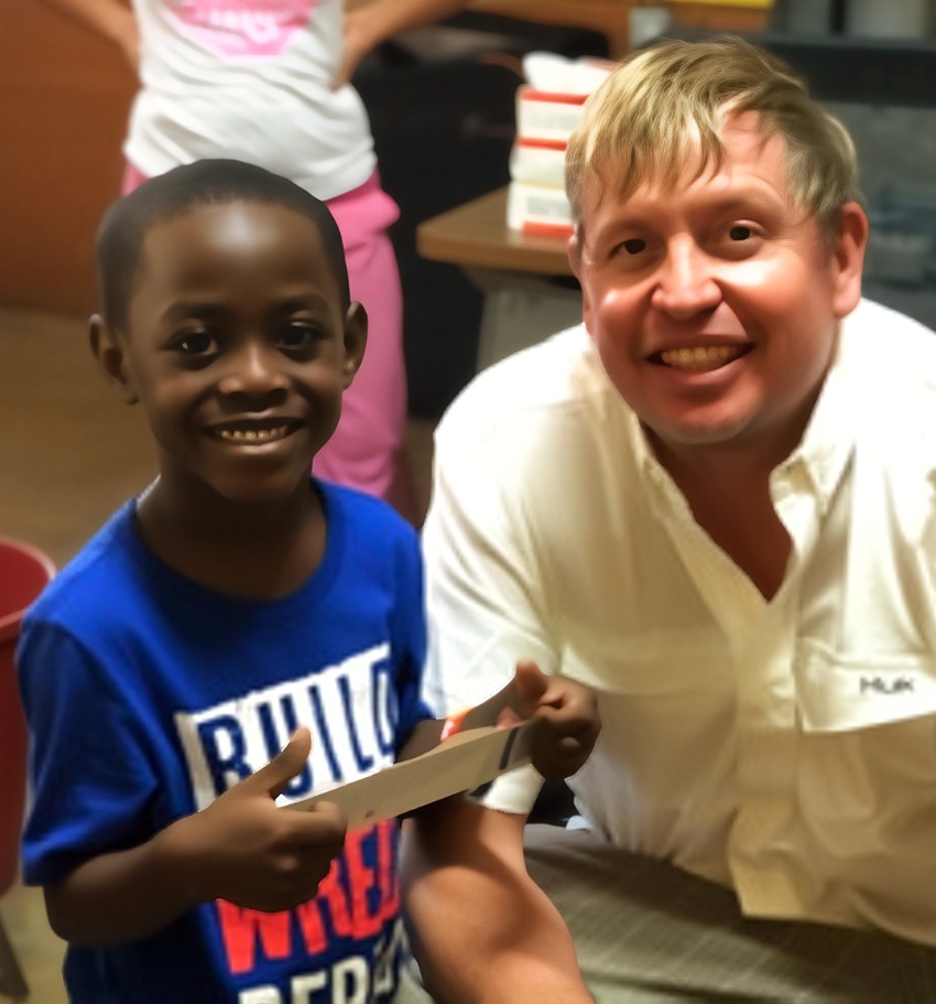 Dr. Will with a young patient after treatment