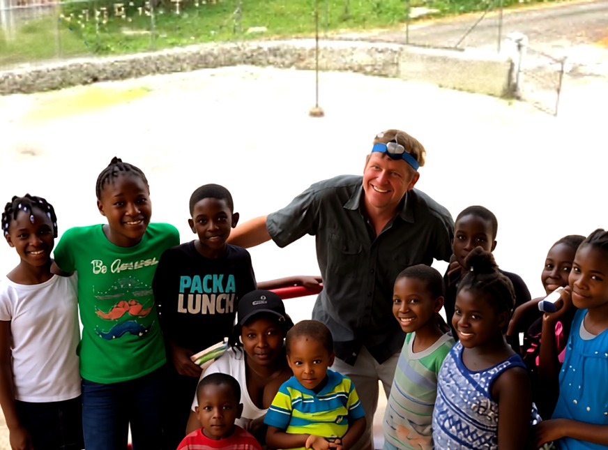 Dr. Christopher Will with children from the community in Jamaica